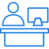 An icon of a person sitting at a desk with a computer monitor and phone, depicted in blue lines.