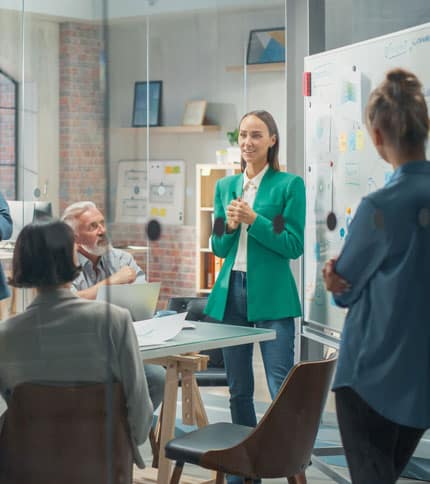 A project manager presenting ideas to a team in a collaborative setting.