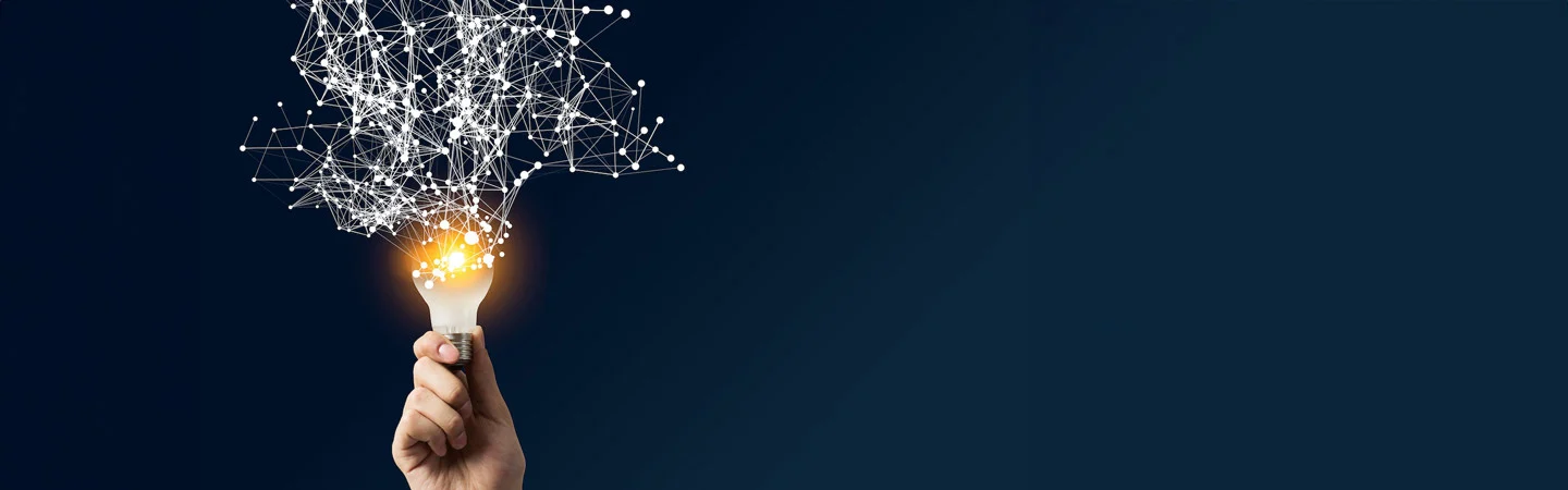 Hand holding a glowing lightbulb with interconnected lines and dots extending upward, resembling a network, against a dark background.