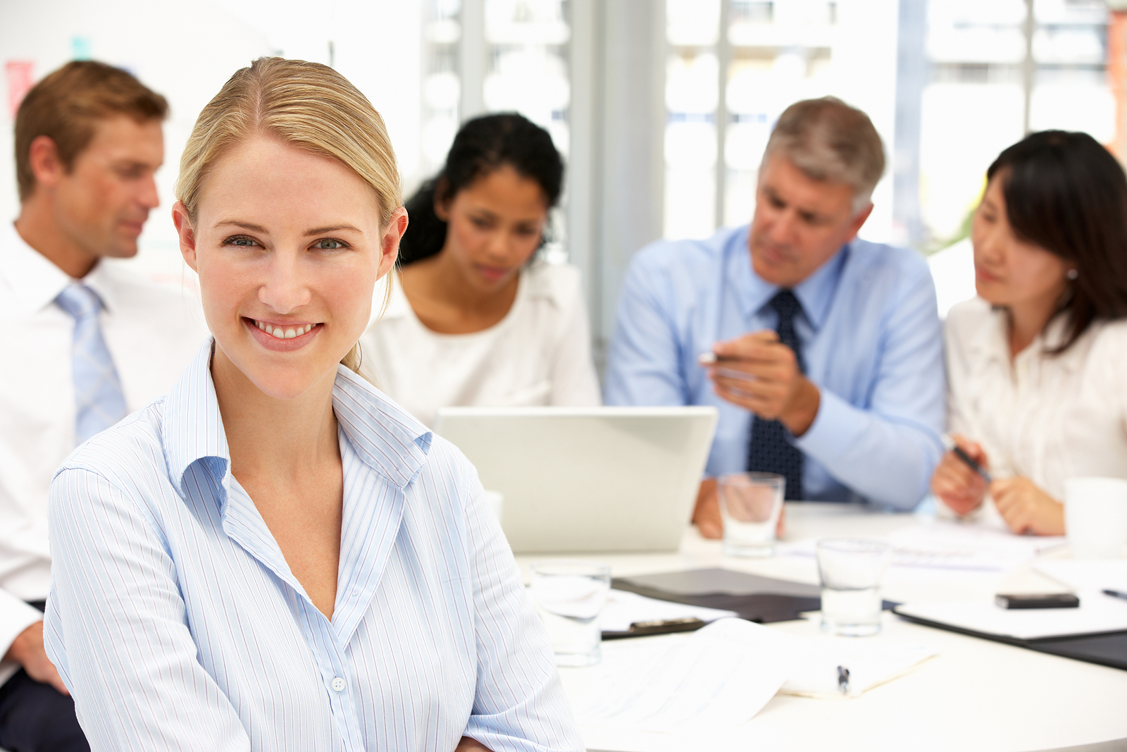 Woman in front of a team meeting