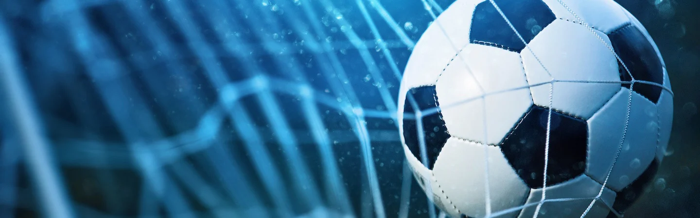 A soccer ball hitting the net, signifying a goal.