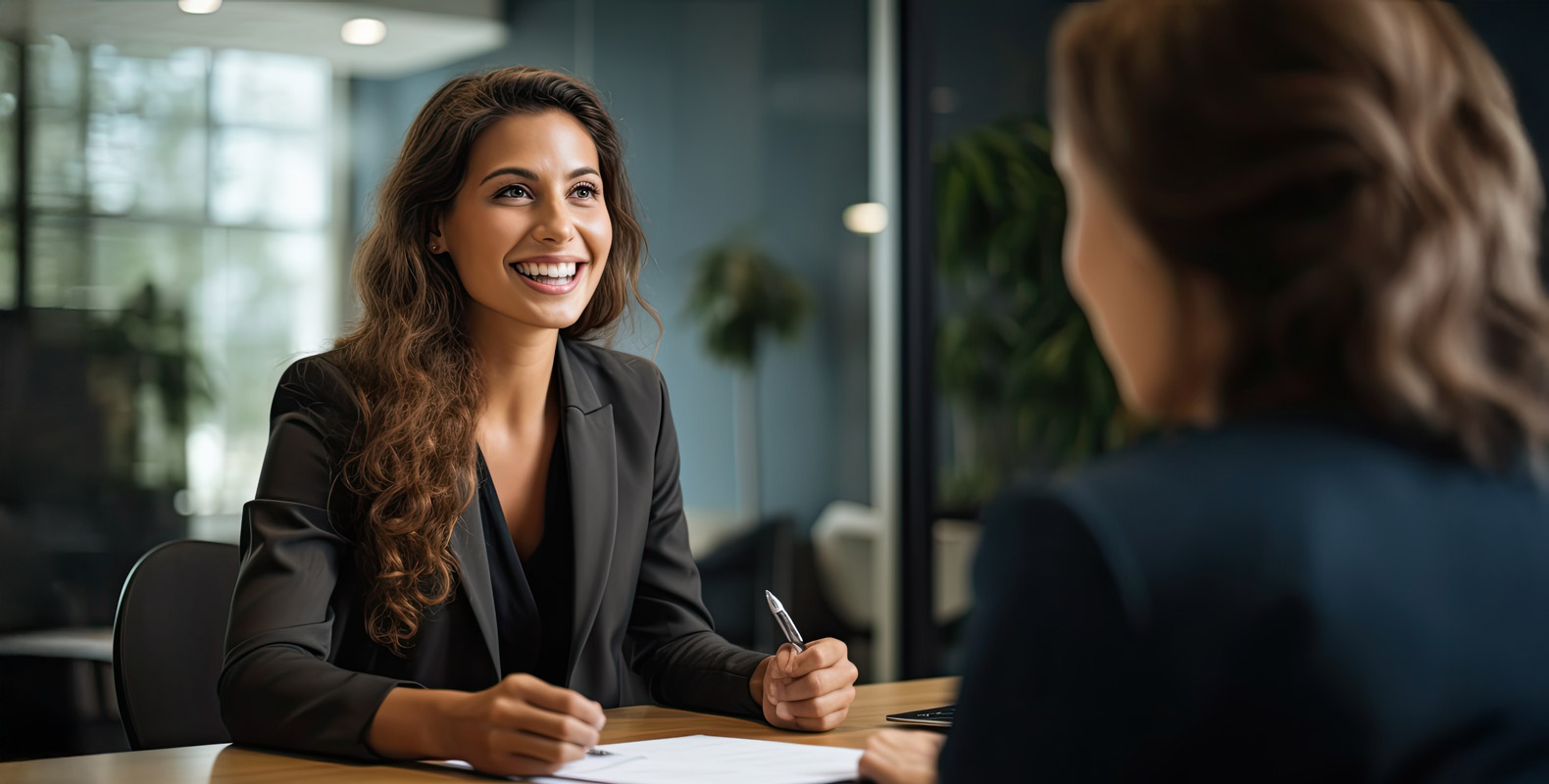 A confident businesswoman smiling during a professional meeting.