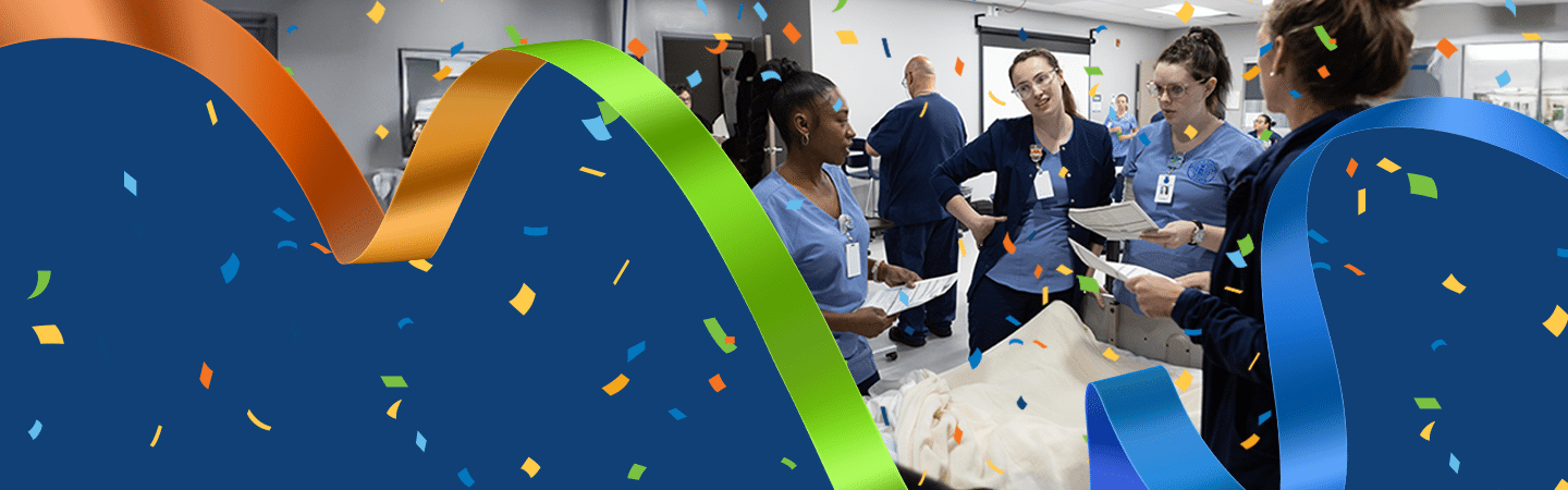 A group of healthcare professionals in scrubs stand around a hospital bed, discussing documents. Colorful ribbons and confetti frame the scene, creating a celebratory atmosphere.