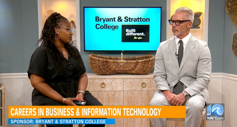 Two people sit and talk in a TV studio. Behind them, a screen displays "Bryant & Stratton College" and "Built different." A banner below highlights careers in Business & Information Technology and the value of Stackable Degrees. Sponsor: Bryant & Stratton College.